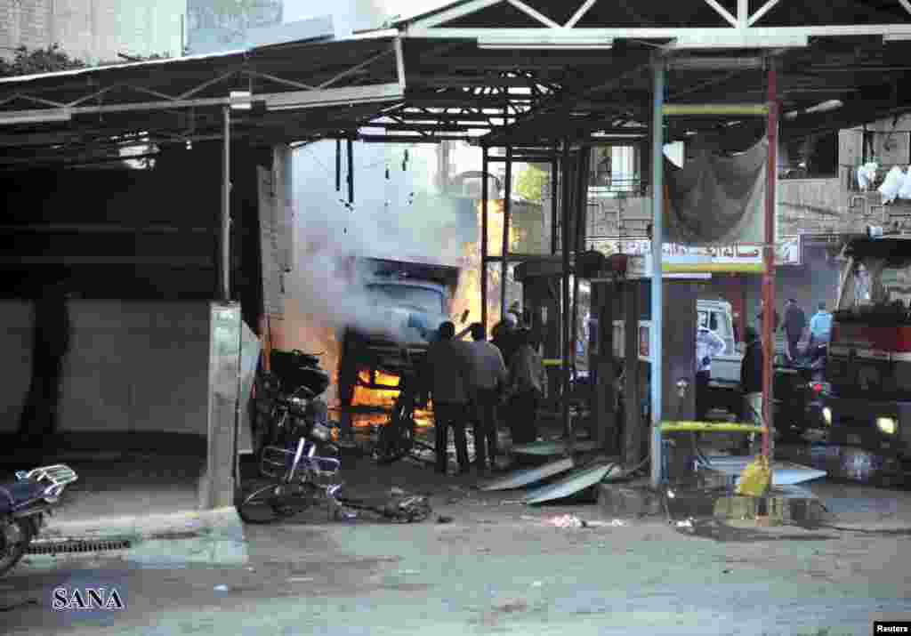 A crowd gathers at a site of a blast in Jaramana district, near Damascus, in this handout photograph released by Syria's national news agency SANA, November 28, 2012. 