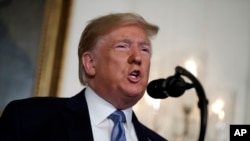 In this Aug. 5, 2019, photo, President Donald Trump speaks about the mass shootings in El Paso, Texas and Dayton, Ohio, in the Diplomatic Reception Room of the White House in Washington.