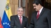 FILE - Cuba's Raul Castro (L) shakes hands with Venezuela's Nicolas Maduro in Caracas, Venezuela, March 5, 2018. 
