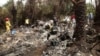 Rescuers on site of plane crash carrying Guinea's military chief, General Kelefa Diallo, and other senior military officials, Charlesville, southeast of Monrovia, Liberia, February 11, 2013.