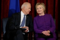 FILE - U.S. Vice President Joe Biden and former Secretary of State Hillary Clinton attend a ceremony to unveil a portrait honoring retiring Senate Minority Leader Harry Reid on Capitol Hill in Washington, Dec. 8, 2016.