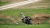Armenian soldiers aim a howitzer, April 3, 2016, in the village of Mardakert, in the separatist region of Nagorno-Karabakh.