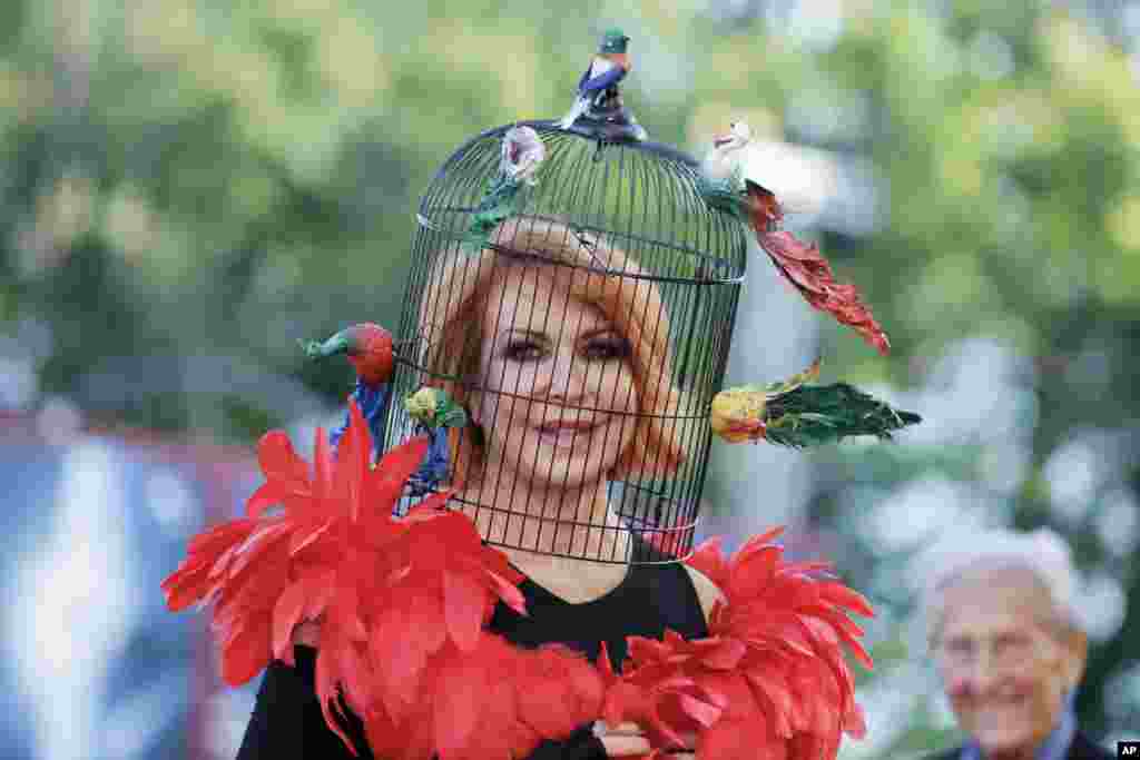 Marina Ripa di Meana wears a bird-cage head dress as she arrives for the screening of the opening film 'Gravity' at the 70th edition of the Venice Film Festival in Venice, Italy.