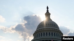 FILE - The dome of the U.S. Capitol Building is seen as the sun sets on Capitol Hill in Washington, July 26, 2019. 