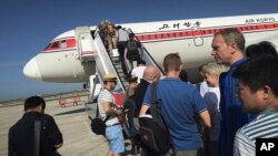 Des passagers embarquent à bord d’un avion à l’aéroport international de Pyongyang, Corée du Nord, 27 juin 2015.
