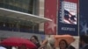 Convention goers use umbrellas to dodge the rain while arriving to the site of the Republican National Convention in Tampa, Florida, August 26, 2012. 