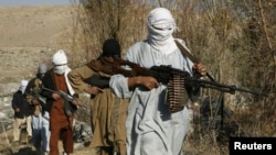 FILE - Armed Taliban fighters are seen at an undisclosed location in Nangarhar province, Afghanistan, Dec. 13, 2010. Taliban fighters are currently engaged in clashes with Islamic State militants in the region.