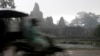 A Cambodian man drives his motor cart past the famed Bayon temple in Angkor complex during the rainy day in Siem Reap province, file photo. 