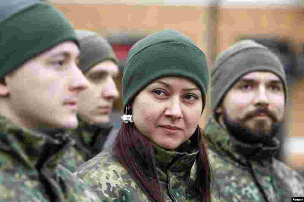 Members of the newly-created Ukrainian Interior Ministry battalion "Saint Maria" take part in a ceremony before heading to military training, in front of St. Sophia Cathedral, in Kyiv, Feb. 3, 2015.