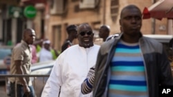 Papa Massata Diack, au centre, fils de l'ancien président de l'IAAF Lamine Diack arrive au commissariat central de Dakar, au Sénégal, le 17 février 2016. 