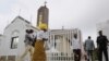 Worshipers arrive at Holy Trinity Catholic Church in Nigeria's capital, Abuja, June 24, 2012. 