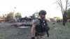 Поліцейський працює на місці російського удару в місті Вільнянськ Запорізької області, 29 червня 2024 року. Фото поширене пресслужбою МВС України
