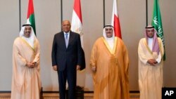 In this July 30, 2017, photo released by Bahrain News Agency, from left to right, Foreign Ministers Abdullah bin Zayed al-Nahyan of the UAE, Sameh Shoukry of Egypt, Khalid bin Ahmed al-Khalifa of Bahrain and Adel al-Jubeir of Saudi Arabia pose for a photo during their meeting in Manama, Bahrain. The four Arab states that cut ties with Qatar met Sunday to discuss the diplomatic crisis.