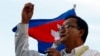 FILE - Cambodian opposition leader Sam Rainsy of the Cambodia National Rescue Party delivers a speech before his party supporters during a rally in Phnom Penh, Cambodia, Sunday, Dec. 22, 2013.