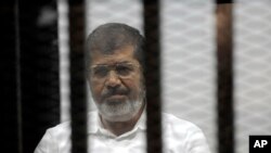 Le président islamiste évincé Mohamed Morsi, au cours d'une audience du tribunal pour incitation à l'assassinat de ses adversaires, au Caire, en Egypte, le 3 novembre 2014.(AP Photo/Mohammed al-Law) 