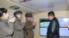 북한 조선중앙통신이 12일 공개한 김정은(오른쪽) 국무위원장의 전날 '극초음속 미사일' 시험 발사 참관 현장.