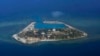 The Vietnamese-claimed Southwest Cay island in the Spratly island group is seen from a Philippine Air Force C-130 transport plane during the visit to the Philippine-claimed Thitu Island by Defense Secretary Delfin Lorenzana, Armed Forces Chief Gen.