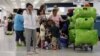 FILE - Passengers wait in line for a flight departing to Cuba at Miami International Airport in Miami, Florida, Sept. 27, 2012.