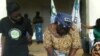 Traditional Authority Chitera signs by-laws as GENET's Joyce Mkandawire looks on (GENET)