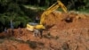 Rescuers work during a rescue and evacuation operation following a landslide at a campsite in Batang Kali