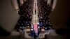 The flag-draped casket of former President George H.W. Bush is carried by a military honor guard during a State Funeral at the National Cathedral, Dec. 5, 2018, in Washington. 