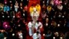 FILE - A bishop, center, accompanied by other clergy members, walks down the aisle during mass at the Cathedral of the Immaculate Conception, a government-sanctioned Catholic church, in Beijing, China, March 31, 2018. 