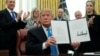 U.S. President Donald Trump displays the "Space Policy Directive 4" after signing the directive to establish a Space Force as the sixth branch of the Armed Forces in the Oval Office at the White House in Washington, Feb. 19, 2019. 